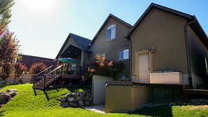 Back of house featuring a yard