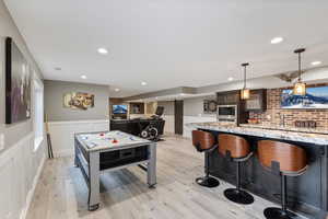 Recreation room with light wood-type flooring