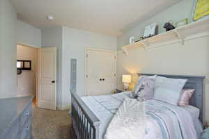 Bedroom with carpet flooring and a closet