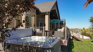 View of property exterior featuring a yard and a hot tub