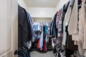 Walk in closet with carpet flooring