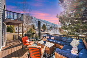 Deck at dusk with a mountain view and an outdoor hangout area