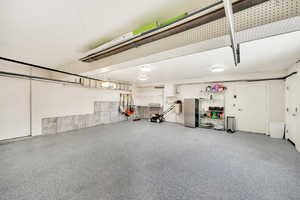 Garage with stainless steel refrigerator