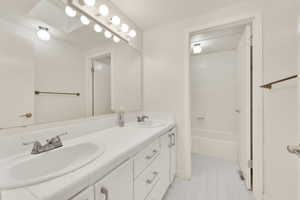 Bathroom with tile patterned floors, vanity, and bathing tub / shower combination