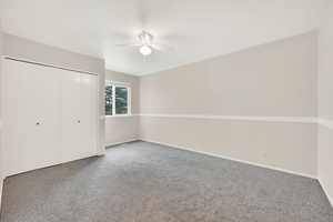 Bedroom featuring carpet floors, a closet, and ceiling fan