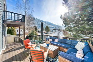 Wooden deck featuring an outdoor living space and a mountain view