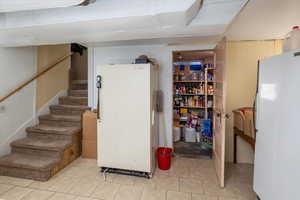 Basement with white fridge