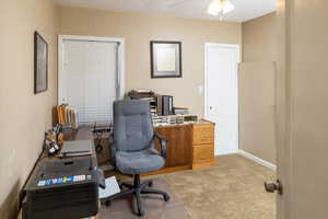 Office space with carpet flooring and ceiling fan