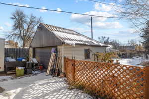 Exterior space featuring a garage and an outdoor structure