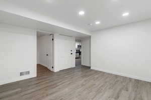 Basement featuring light hardwood / wood-style flooring