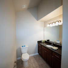 Bathroom with tile patterned flooring, vanity, and toilet