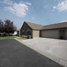 Single story home with a garage and central air condition unit