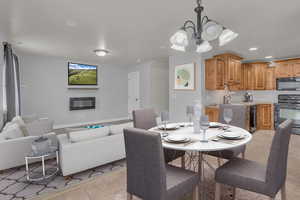 Tiled dining room with a notable chandelier