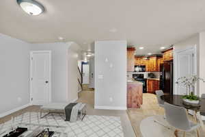 Kitchen with light tile patterned floors and black appliances