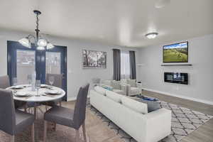 Living room featuring hardwood / wood-style flooring and an inviting chandelier