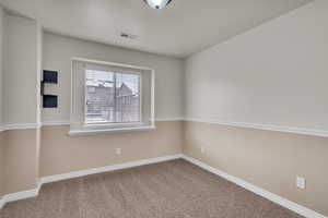 Unfurnished room featuring carpet flooring