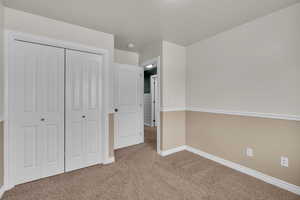 Unfurnished bedroom with carpet and a closet