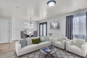 Living room featuring light hardwood / wood-style flooring and an inviting chandelier