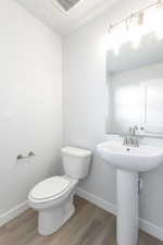 Bathroom featuring wood-type flooring and toilet