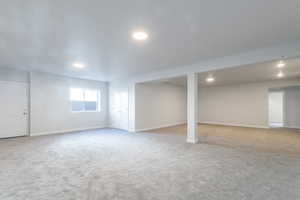 Basement with light colored carpet