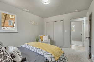 Master bedroom featuring multiple windows and a closet