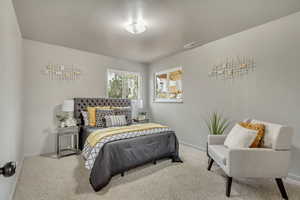 Master bedroom featuring light carpet