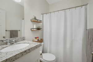 Bathroom featuring vanity and toilet