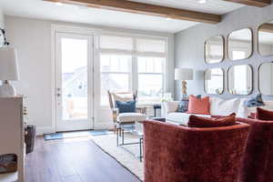 Living room featuring beamed ceiling and wood-type flooring