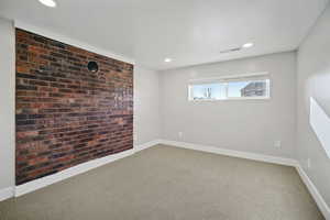 Bedroom with brick wall feature and window