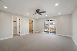 Primary bedroom featuring access to outside deck, ceiling fan, primary bathroom and walk-in closet