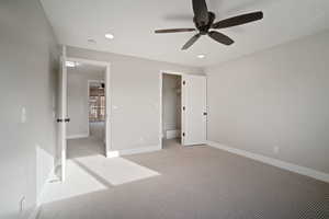 Bedroom featuring ceiling fan and a walk in closet