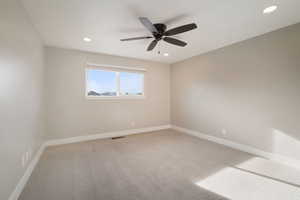 Bedroom featuring ceiling fan and window with a view