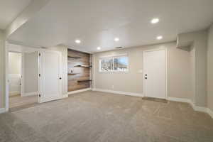 Living Room featuring wood wall with floating shelves and access to multi-level patio