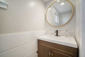 Half bathroom with vanity and shiplap decor