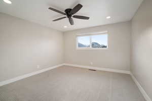 Bedroom featuring ceiling fan and window with a view