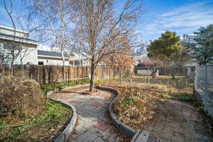 View of landscaped yard and paved rose garden