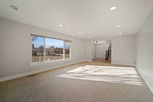 Living Room with gas fireplace and large active window showcasing beautiful views