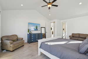 Bedroom with ceiling fan, high vaulted ceiling, and light hardwood / wood-style flooring