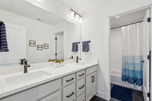 Bathroom with vanity and shower / bath combo