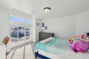 Carpeted bedroom featuring multiple windows