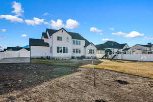 Rear view of property featuring a yard and a playground