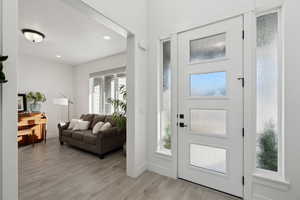 Entryway with a wealth of natural light and light hardwood / wood-style flooring