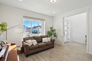 Living room with light hardwood / wood-style flooring