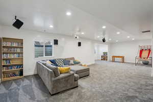 Carpeted living room with a textured ceiling