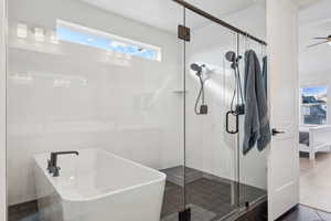 Bathroom with ceiling fan and plus walk in shower