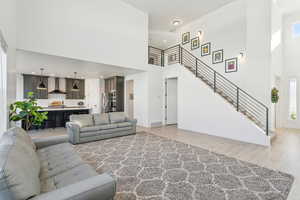 Living room featuring a towering ceiling and light wood-type flooring