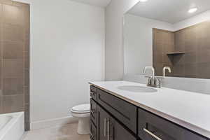 Bathroom featuring tile patterned floors, vanity, and toilet