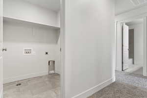 Laundry room featuring hookup for an electric dryer, hookup for a washing machine, and light colored carpet