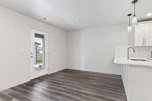 Interior space featuring a textured ceiling, dark hardwood / wood-style floors, and sink