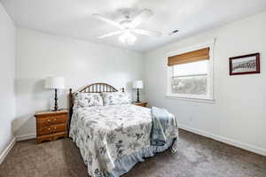 Bedroom with ceiling fan and carpet floors